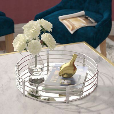 the perfect Circle Glass Tray-Silver Vanity Tray for all your vanity needs! This sleek, circular tray is designed to hold all your everyday essentials while adding a touch of elegance to your space
